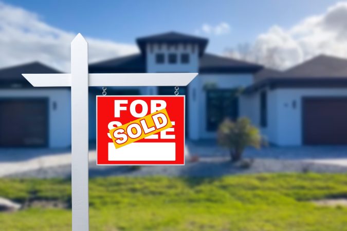 Sold,Home,For,Sale,Sign,In,Front,Of,New,House